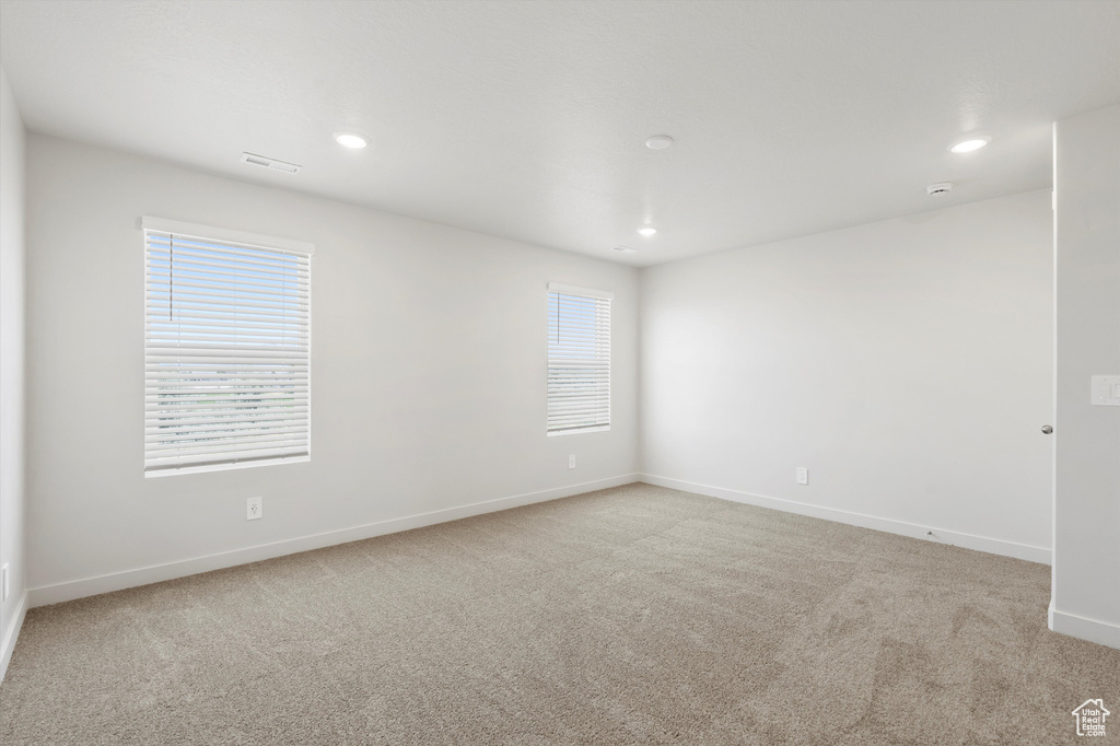 Unfurnished room featuring light carpet and recessed lighting