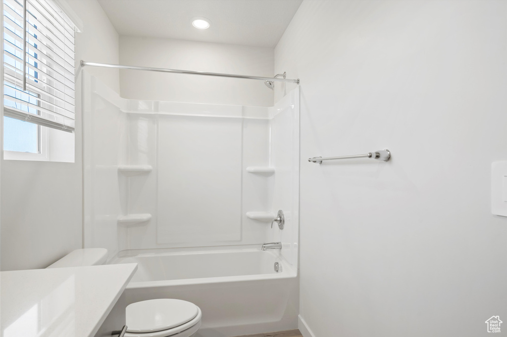 Bathroom featuring vanity, shower / bath combination, and recessed lighting