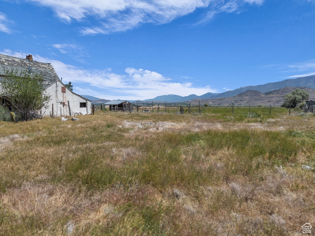 View of mountain background featuring rural landscape