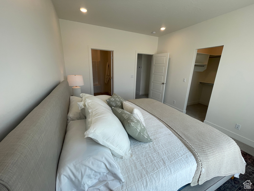 Carpeted bedroom featuring recessed lighting, a spacious closet, and baseboards