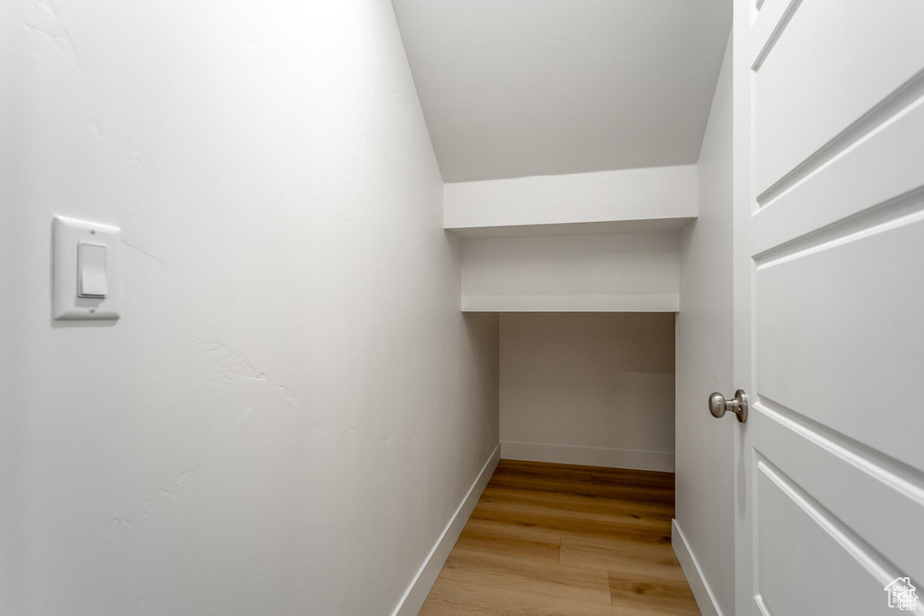 Spacious closet with light wood-style flooring