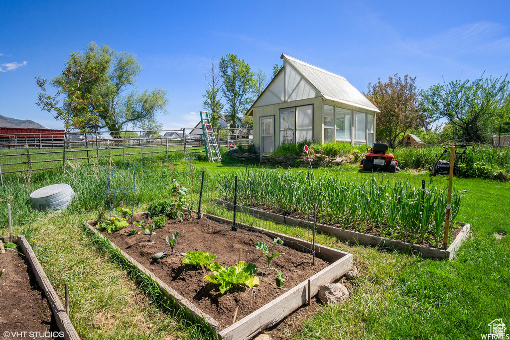 View of yard with a vegetable garden, an exterior structure, and an outdoor structure