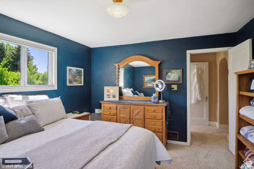 Bedroom featuring light colored carpet and baseboards
