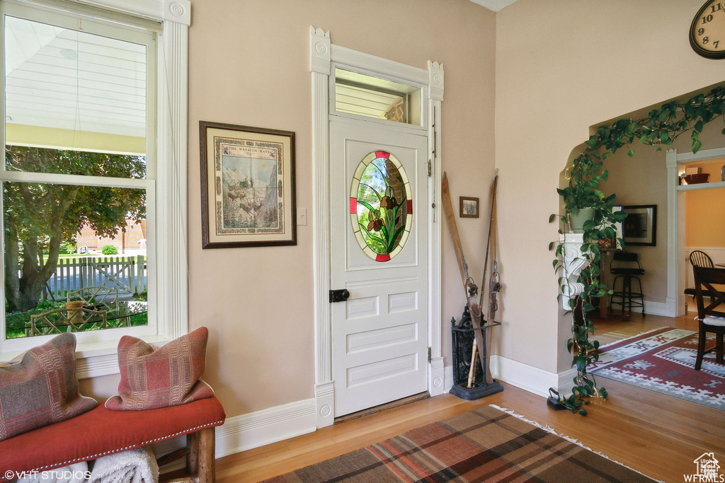 Foyer featuring baseboards and wood finished floors