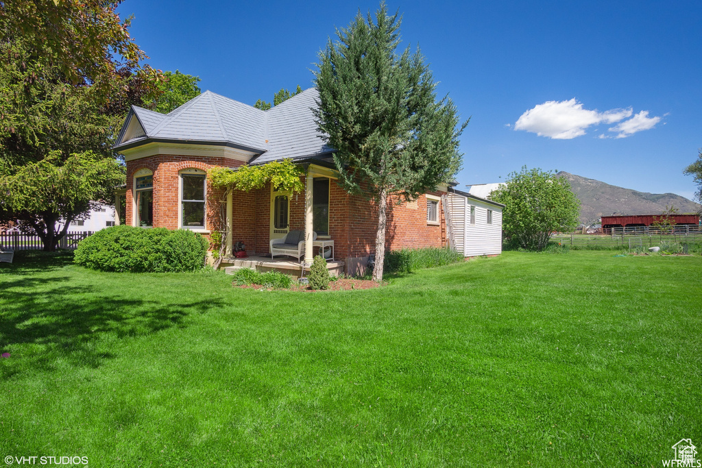 View of front of home with brick siding and a mountain view