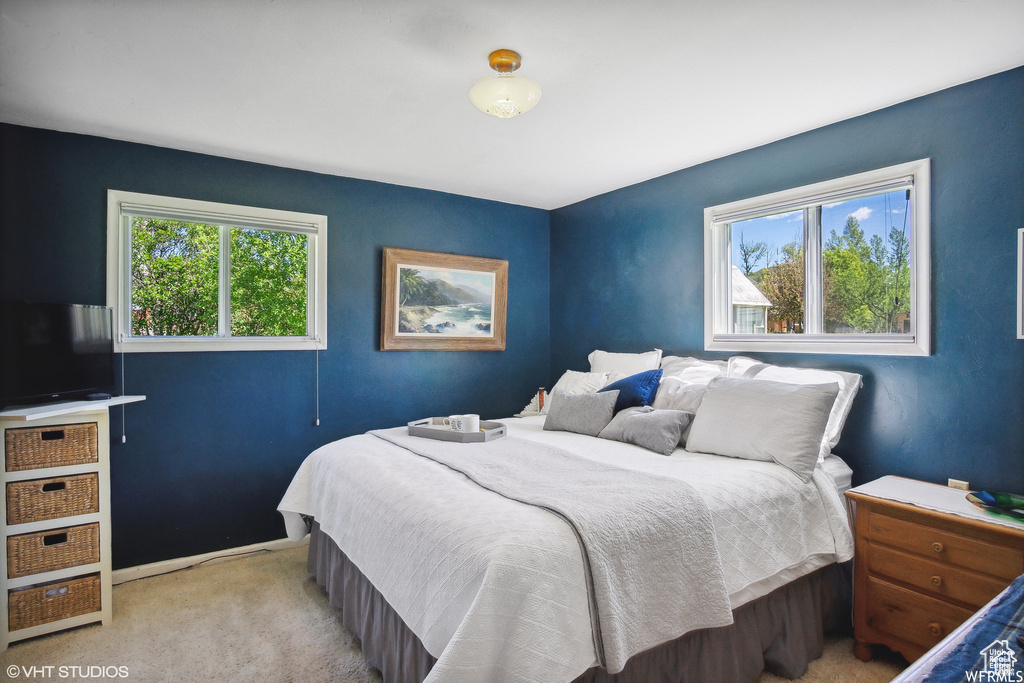 Bedroom with light carpet and baseboards
