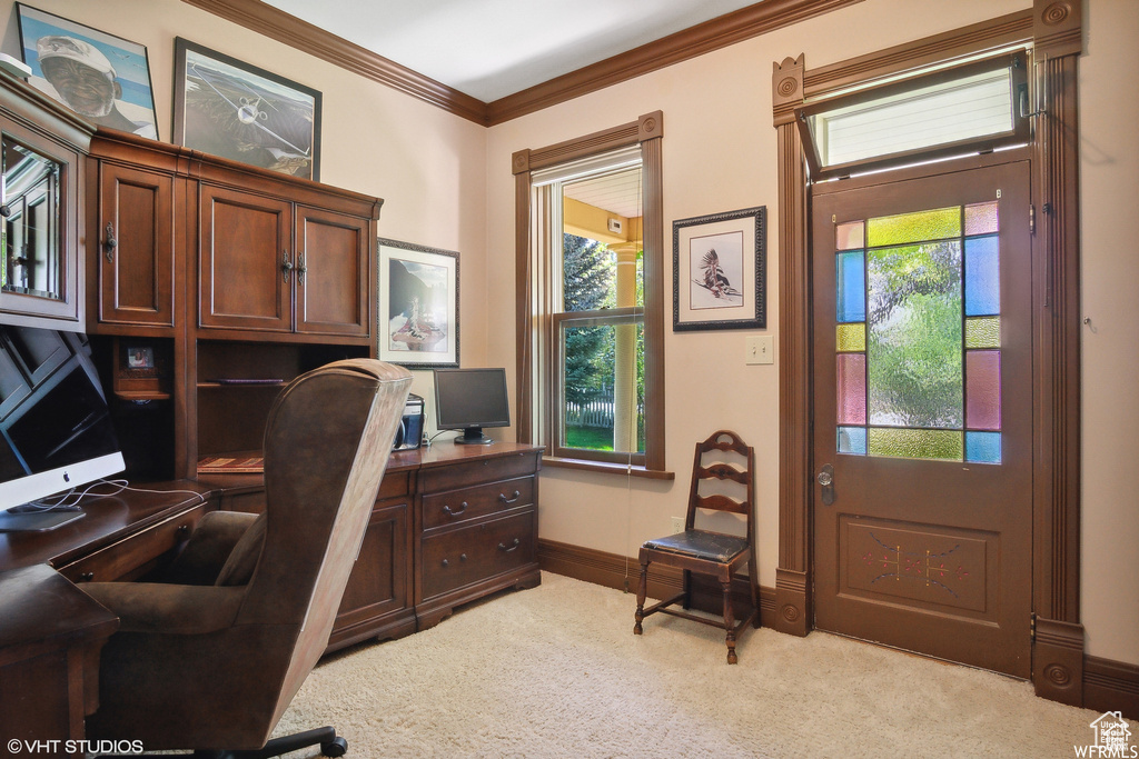 Carpeted office with healthy amount of natural light, ornamental molding, and baseboards