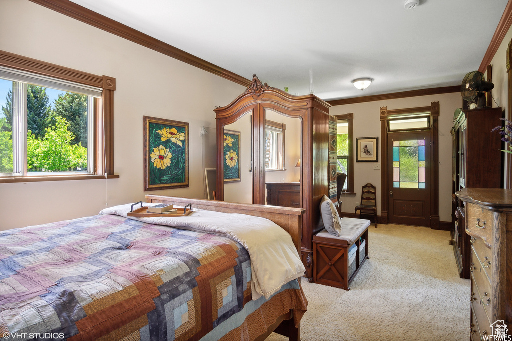 Bedroom with light carpet and ornamental molding