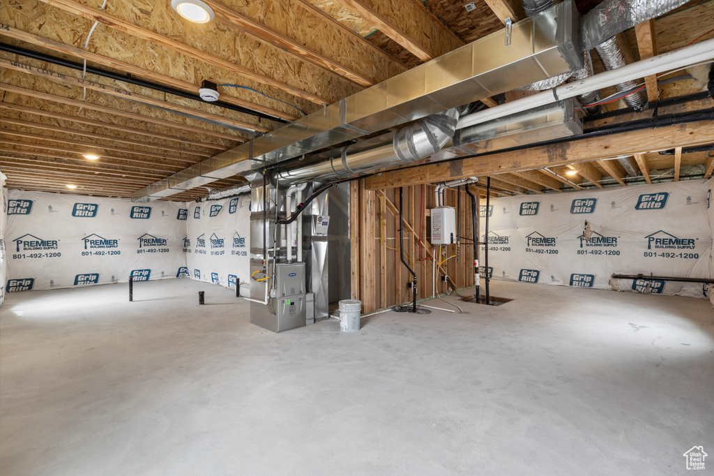 Unfinished below grade area featuring heating unit