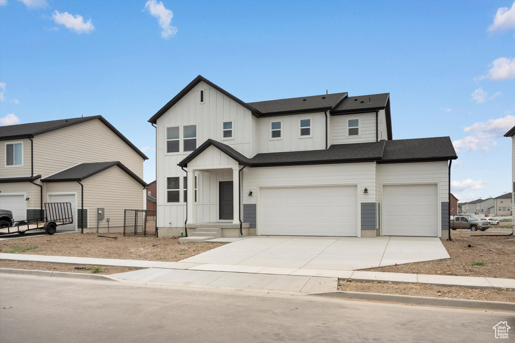 Modern farmhouse style home featuring board and batten siding, concrete driveway, and a garage