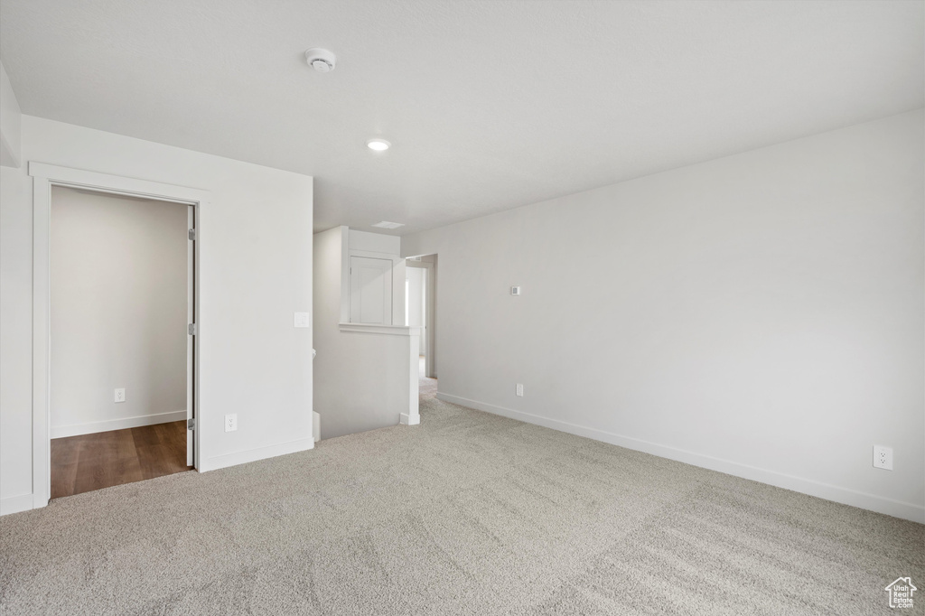 Unfurnished bedroom featuring carpet flooring, recessed lighting, and a spacious closet