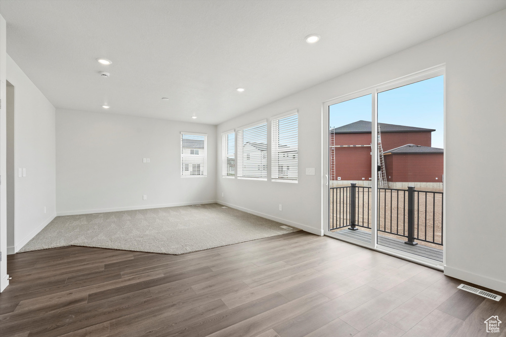 Empty room with wood finished floors and recessed lighting