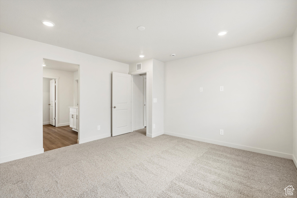 Spare room featuring carpet and recessed lighting