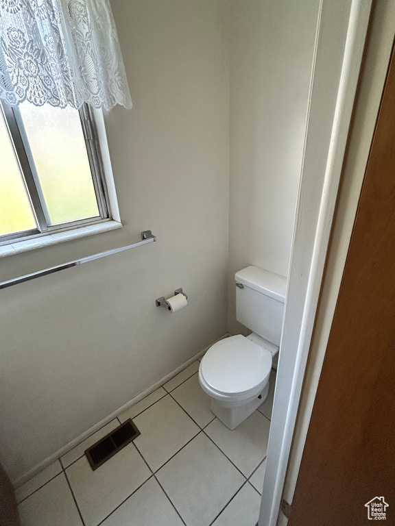 Bathroom with toilet and tile patterned flooring