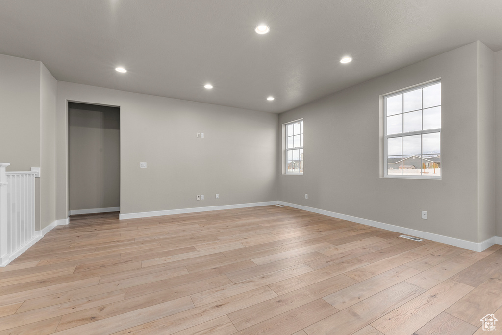 Spare room with light wood-style floors, recessed lighting, and baseboards