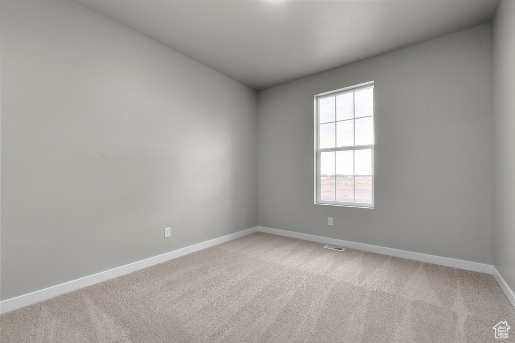 Empty room with baseboards and light carpet