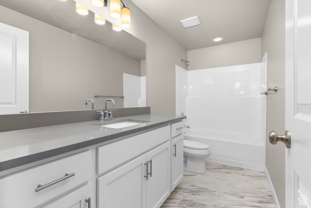 Full bathroom featuring vanity, marble finish flooring, toilet, and shower / bathtub combination