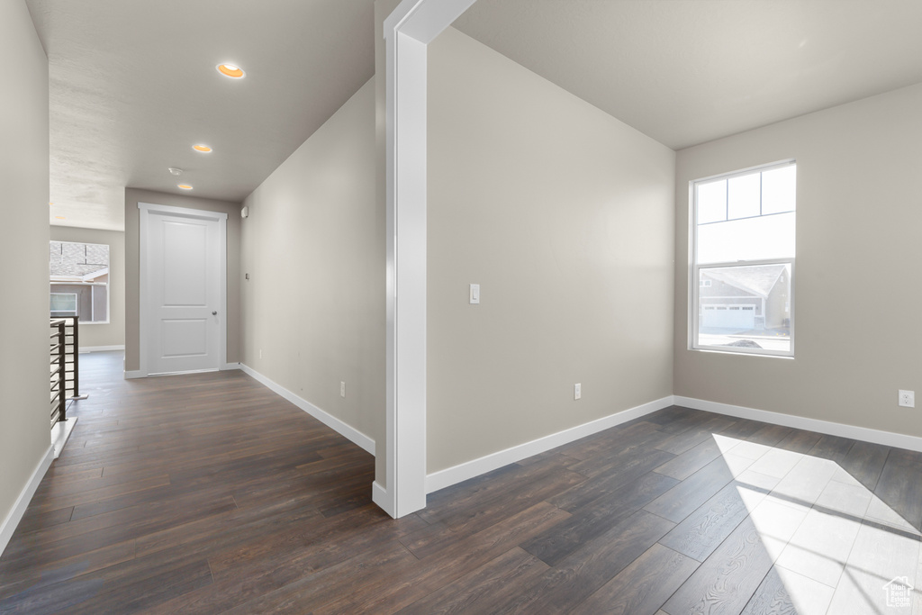 Hall with dark wood-style floors, recessed lighting, and baseboards