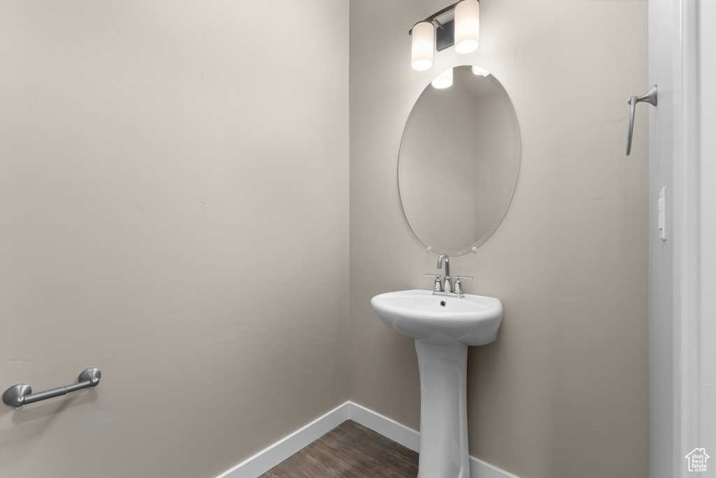 Bathroom with baseboards and wood finished floors