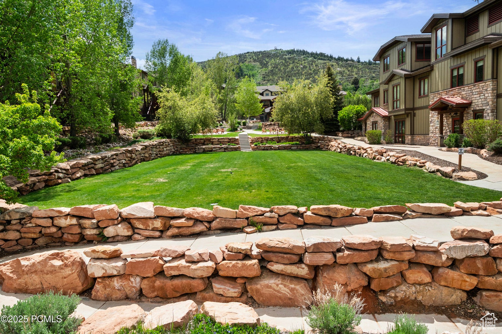 View of grassy yard with a mountain view