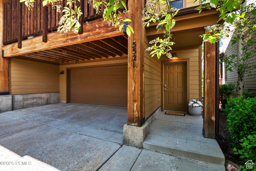 Garage featuring concrete driveway