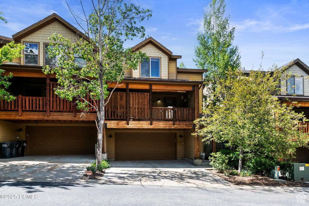 View of front of home with concrete driveway and an attached garage