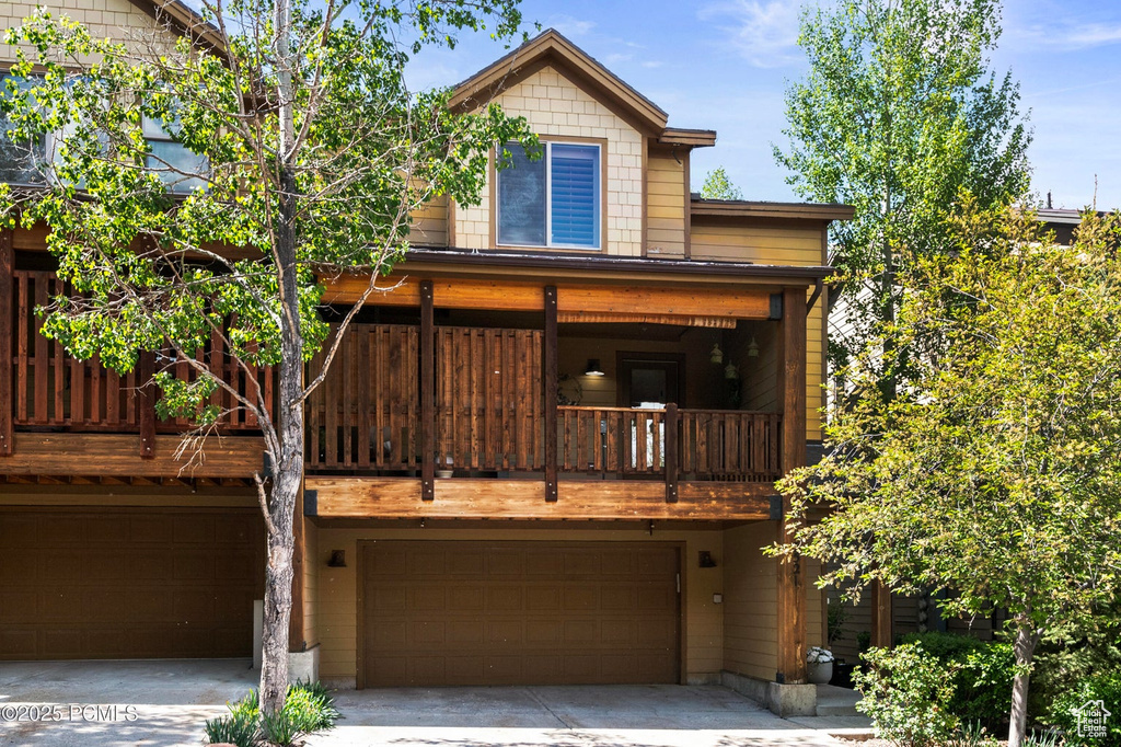 Rear view of house with a garage and driveway