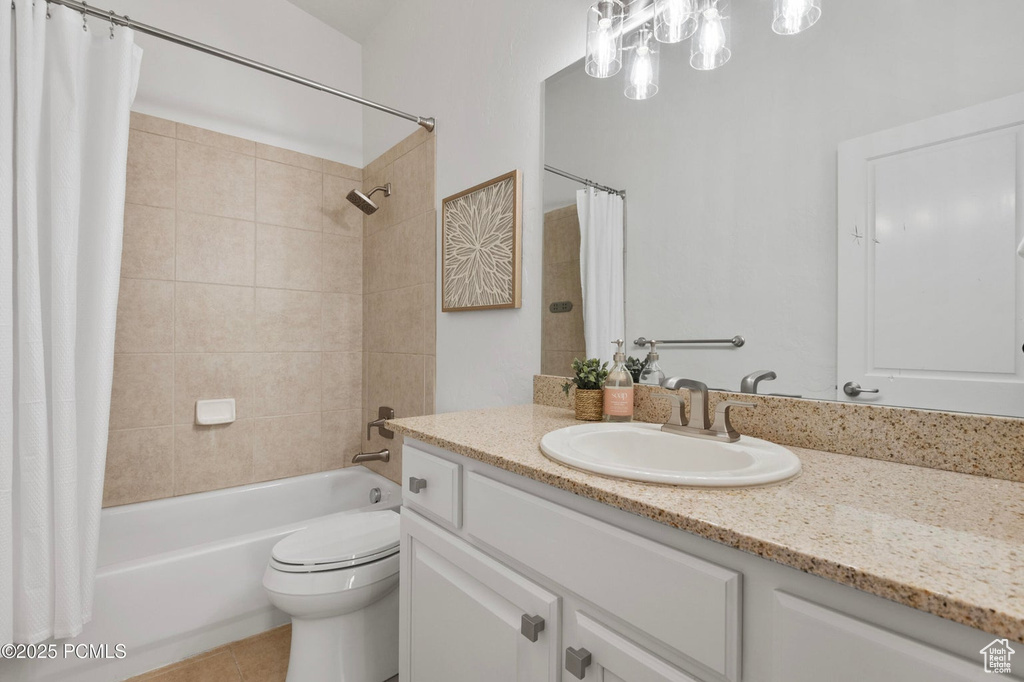 Full bath with vanity, shower / bath combination with curtain, toilet, and tile patterned floors