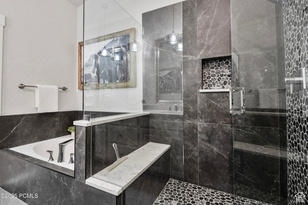 Full bathroom with a stall shower and a bath