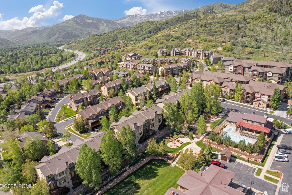 Aerial view of property\'s location with nearby suburban area and mountains