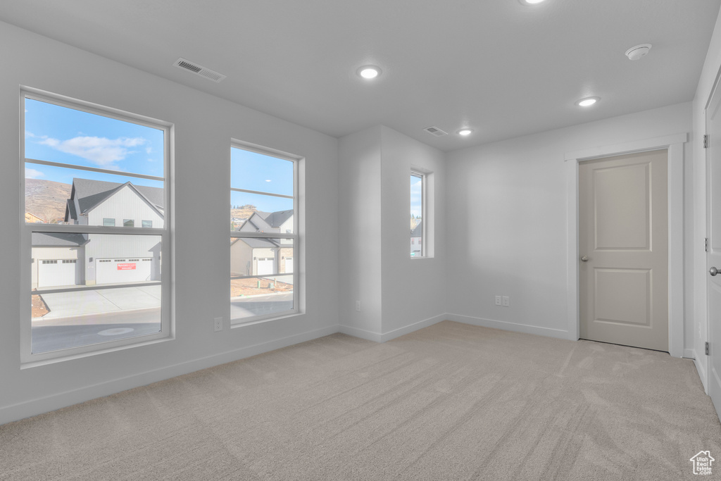 Unfurnished room with carpet floors, baseboards, recessed lighting, and a smoke detector