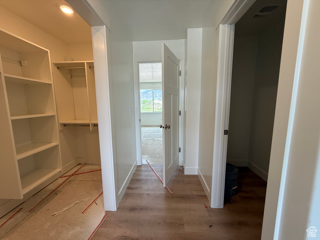 Hall featuring light wood-style floors and baseboards