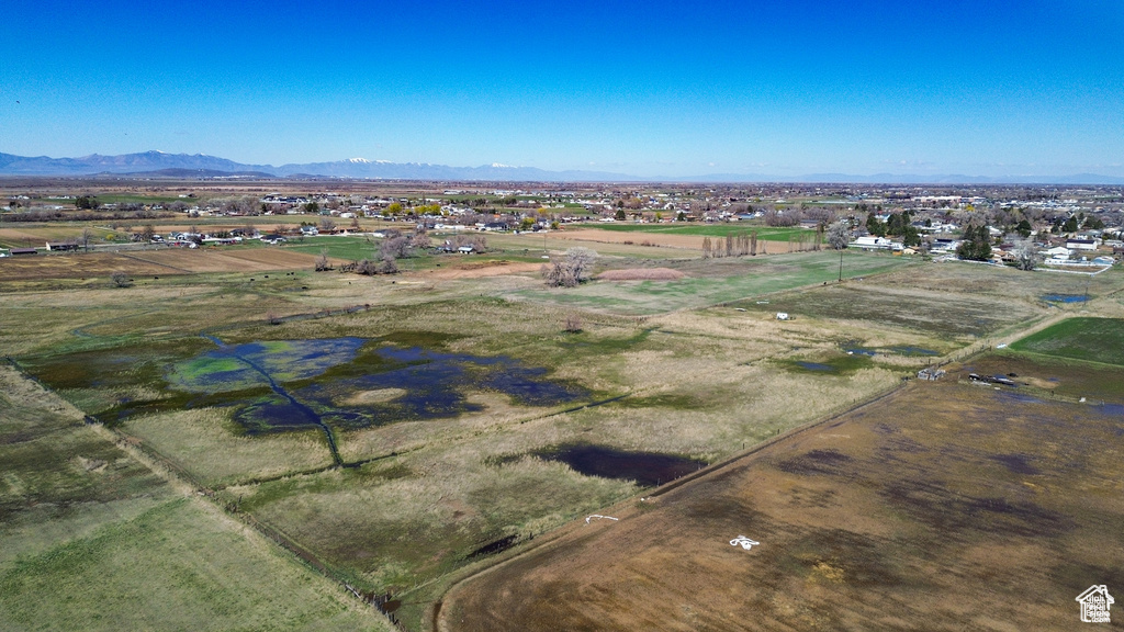 Aerial view of property's location featuring a mountainous background