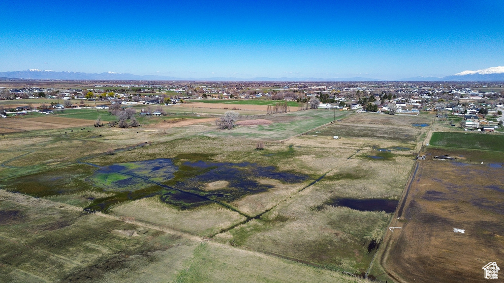 Aerial view of property and surrounding area featuring mountains