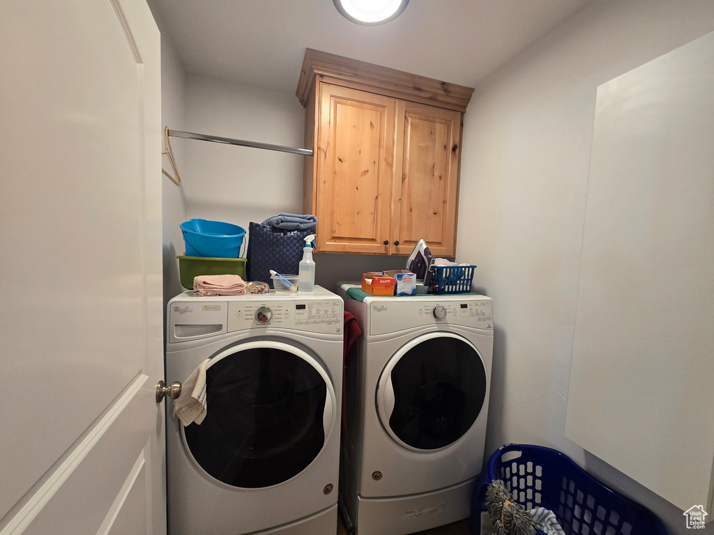 Laundry area with cabinet space and separate washer and dryer