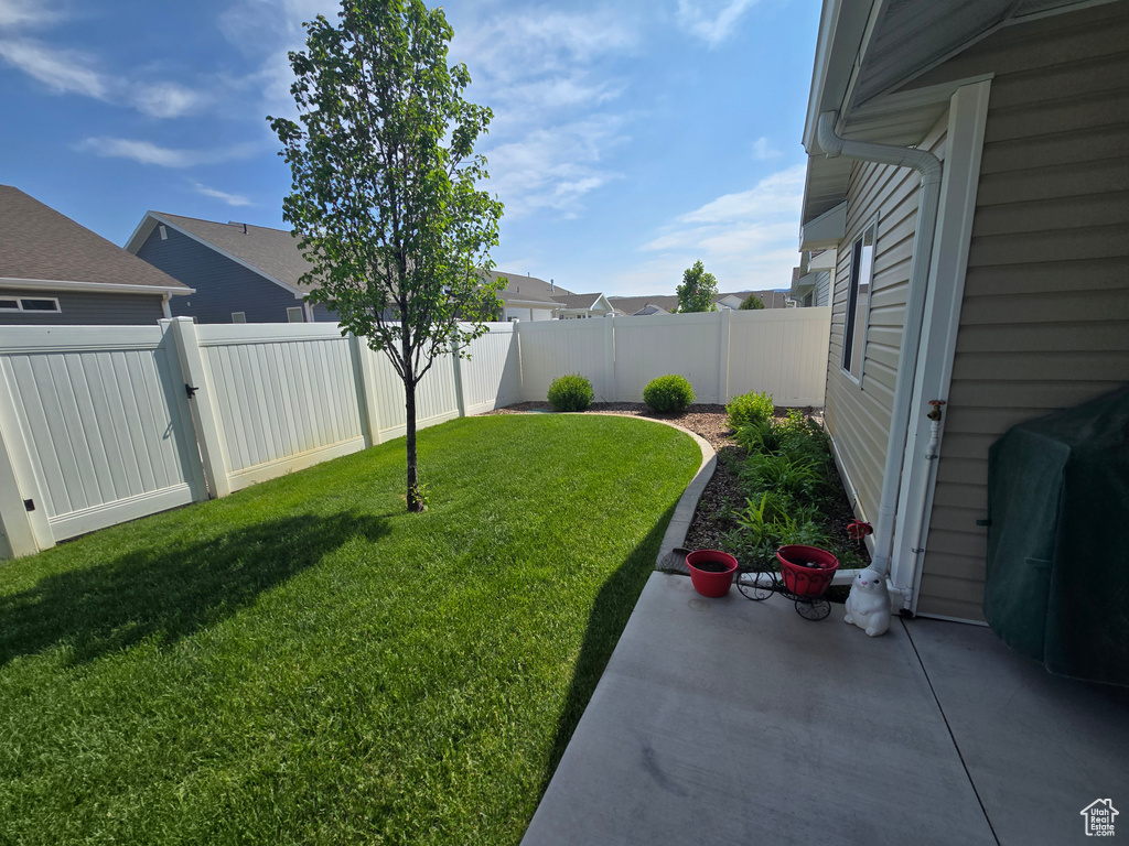 View of yard featuring a patio area and a gate