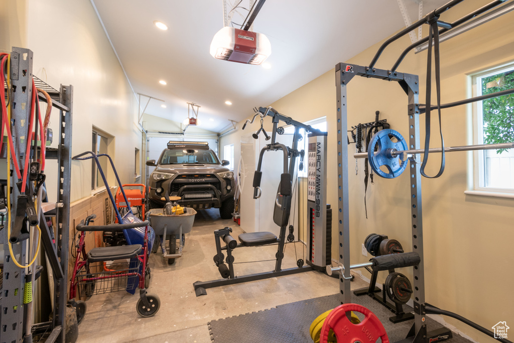 Workout room featuring recessed lighting, a garage, and lofted ceiling