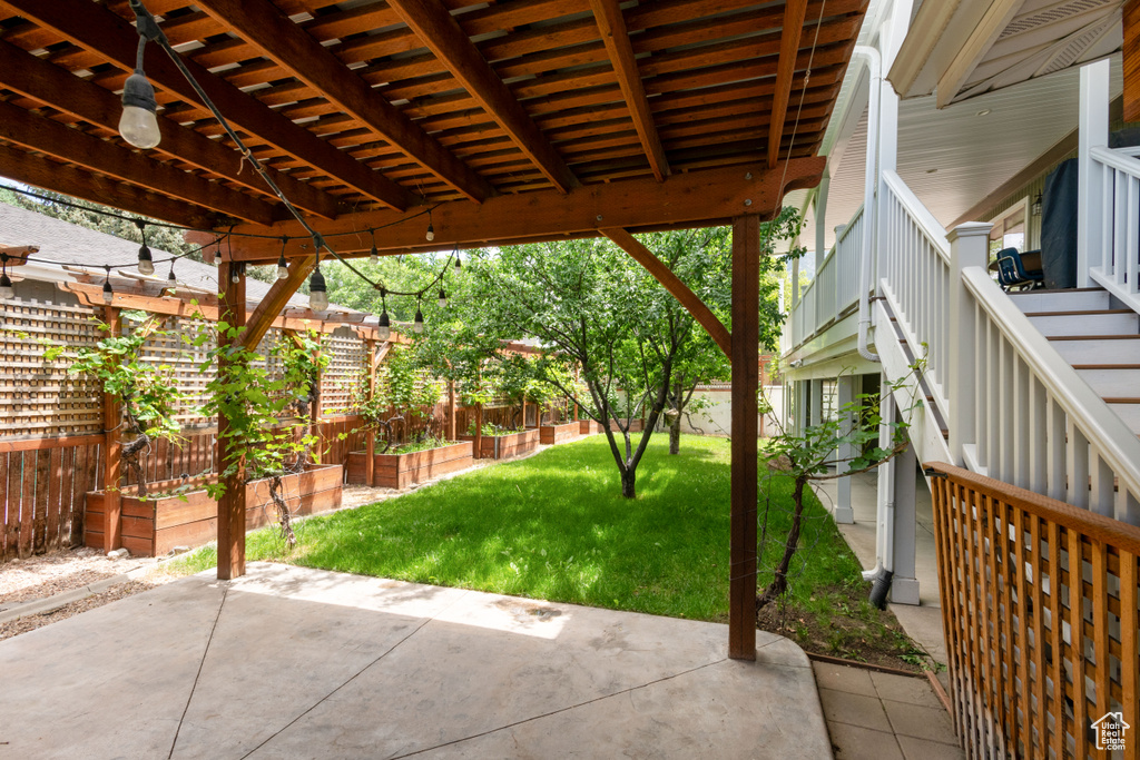 View of patio / terrace featuring a garden and stairs