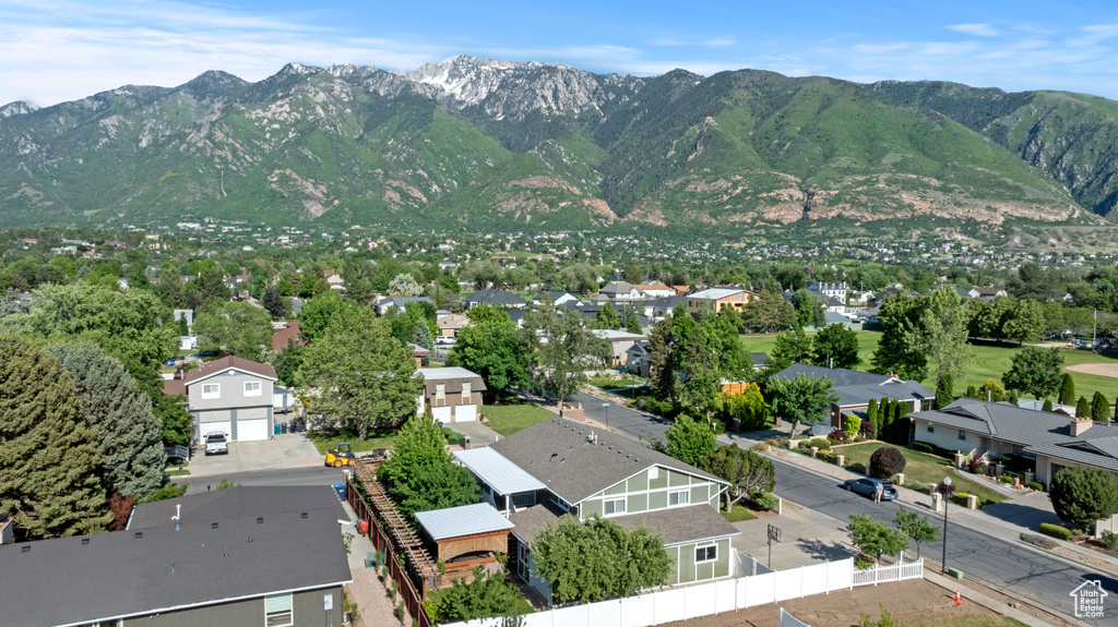 Aerial view of residential area featuring a mountainous background