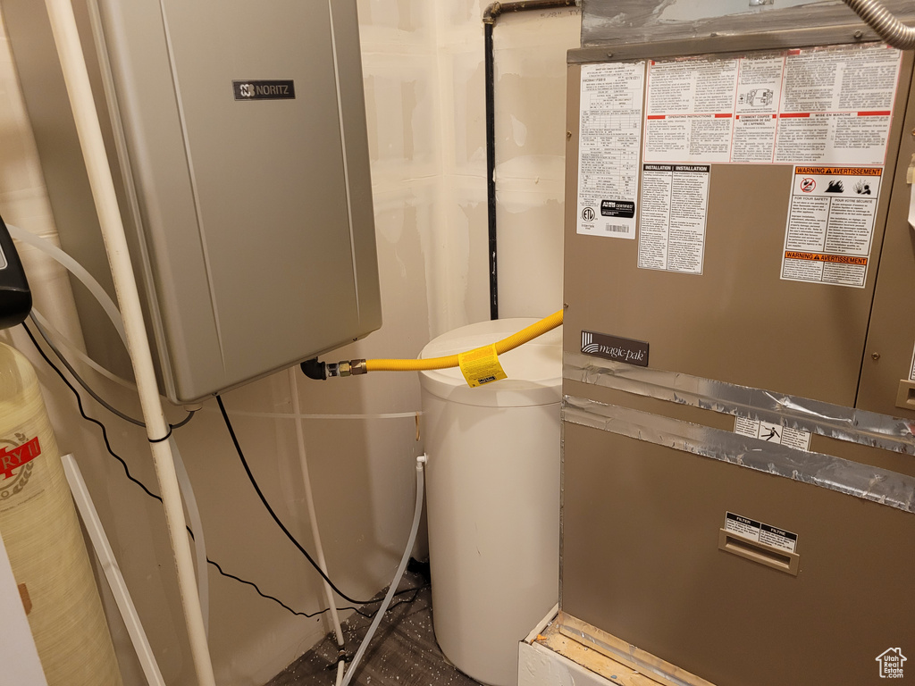 Utility room featuring heating unit