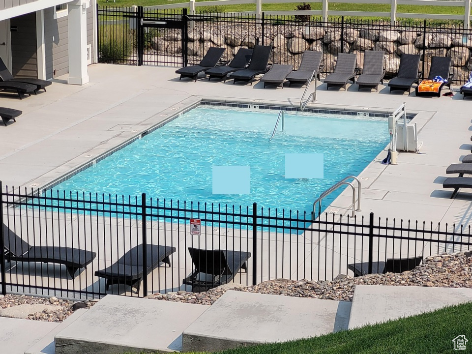Community pool with a patio area