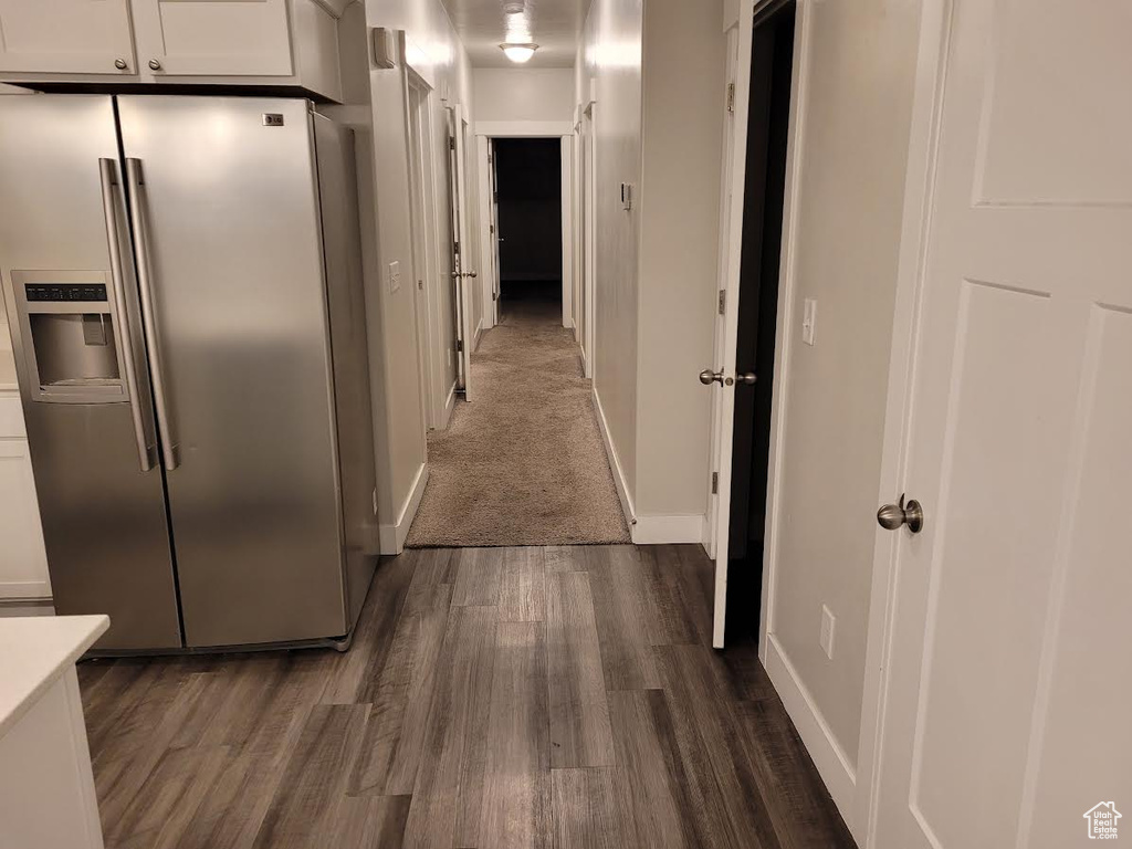 Hallway with dark wood finished floors and baseboards