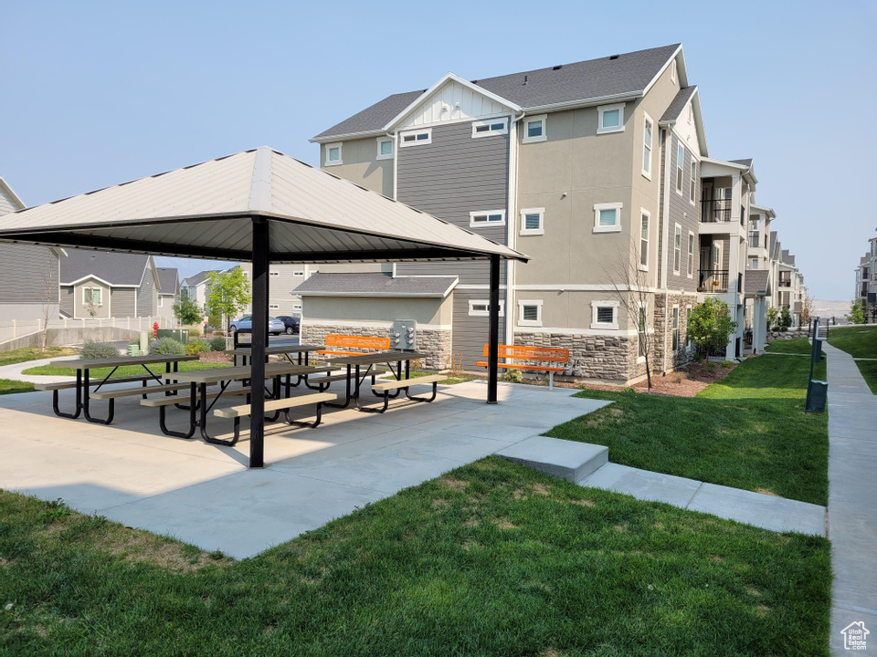 Surrounding community with a gazebo, a residential view, and a yard