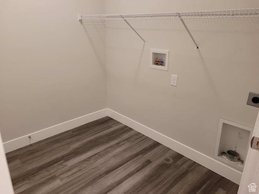 Washroom with electric dryer hookup, baseboards, dark wood-style flooring, and hookup for a washing machine