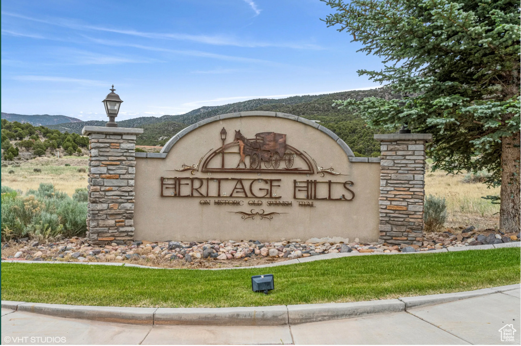 Community / neighborhood sign with a mountain view