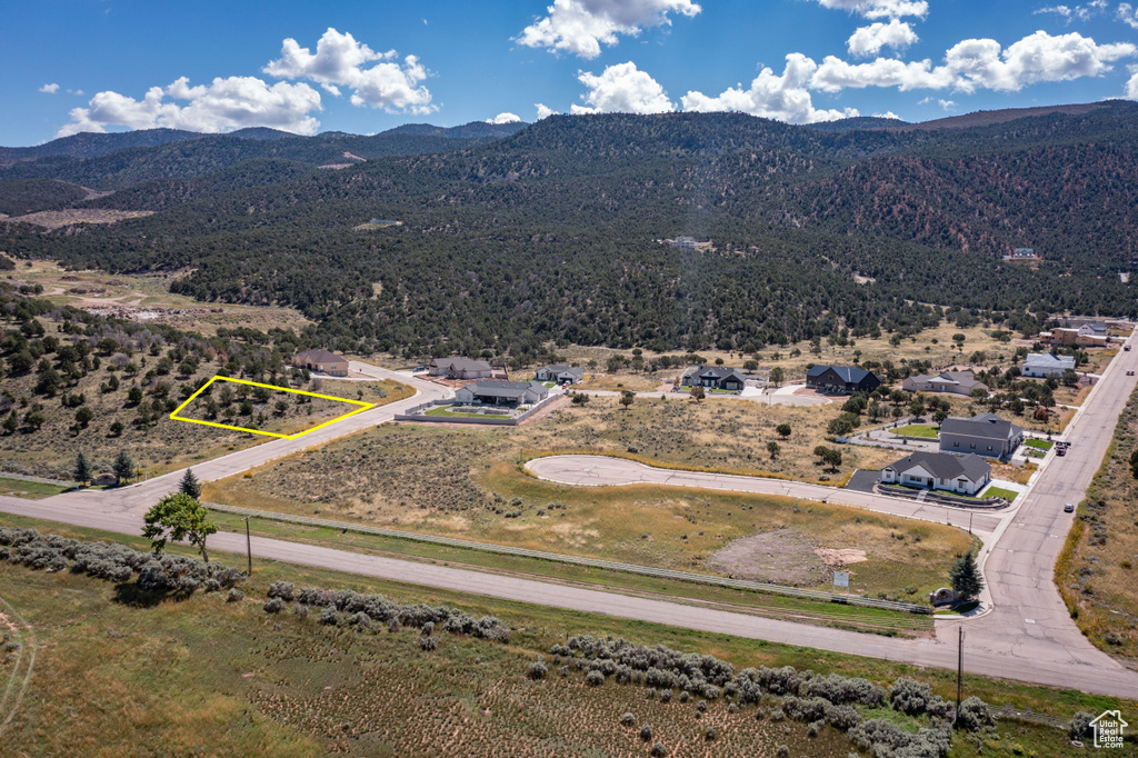 Aerial view of property's location featuring a mountainous background and property boundaries highlighted