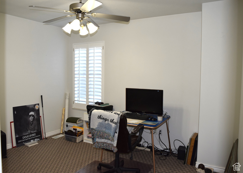 Office space featuring ceiling fan, carpet, and baseboards