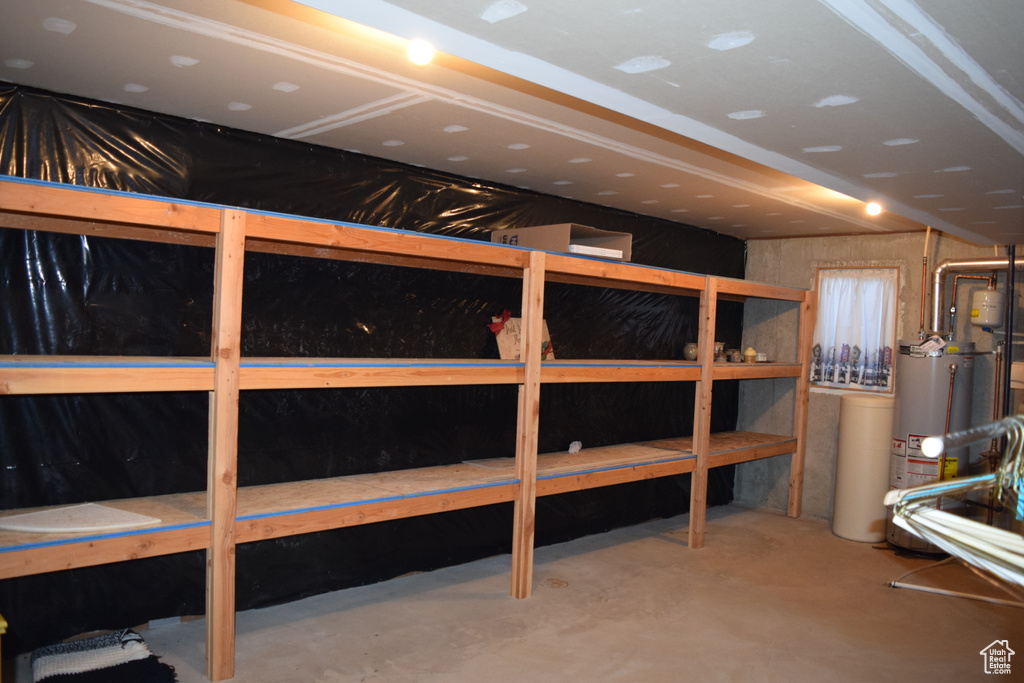 Storage room featuring water heater
