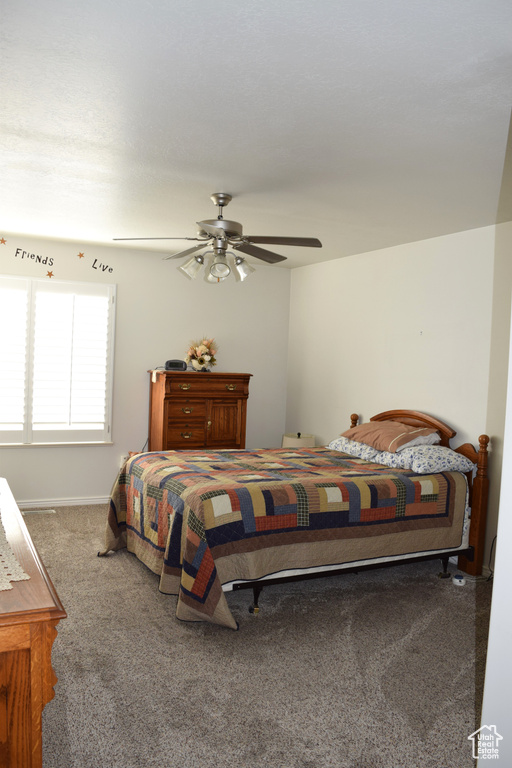 Bedroom with carpet floors, a ceiling fan, and baseboards