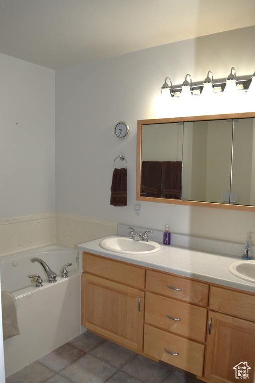 Full bath with double vanity and a garden tub